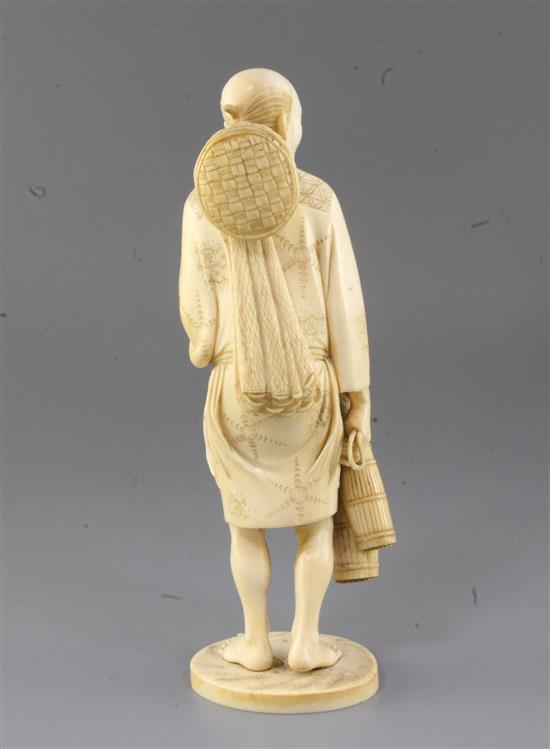 A Japanese ivory okimono of a fisherman, Meiji period, 26cm